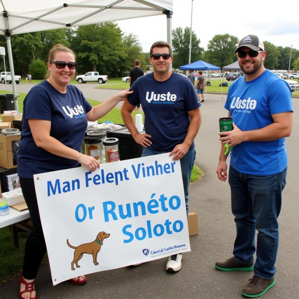  Volunteers holding signs promoting animal welfare at a local event in Williamsburg, Virginia