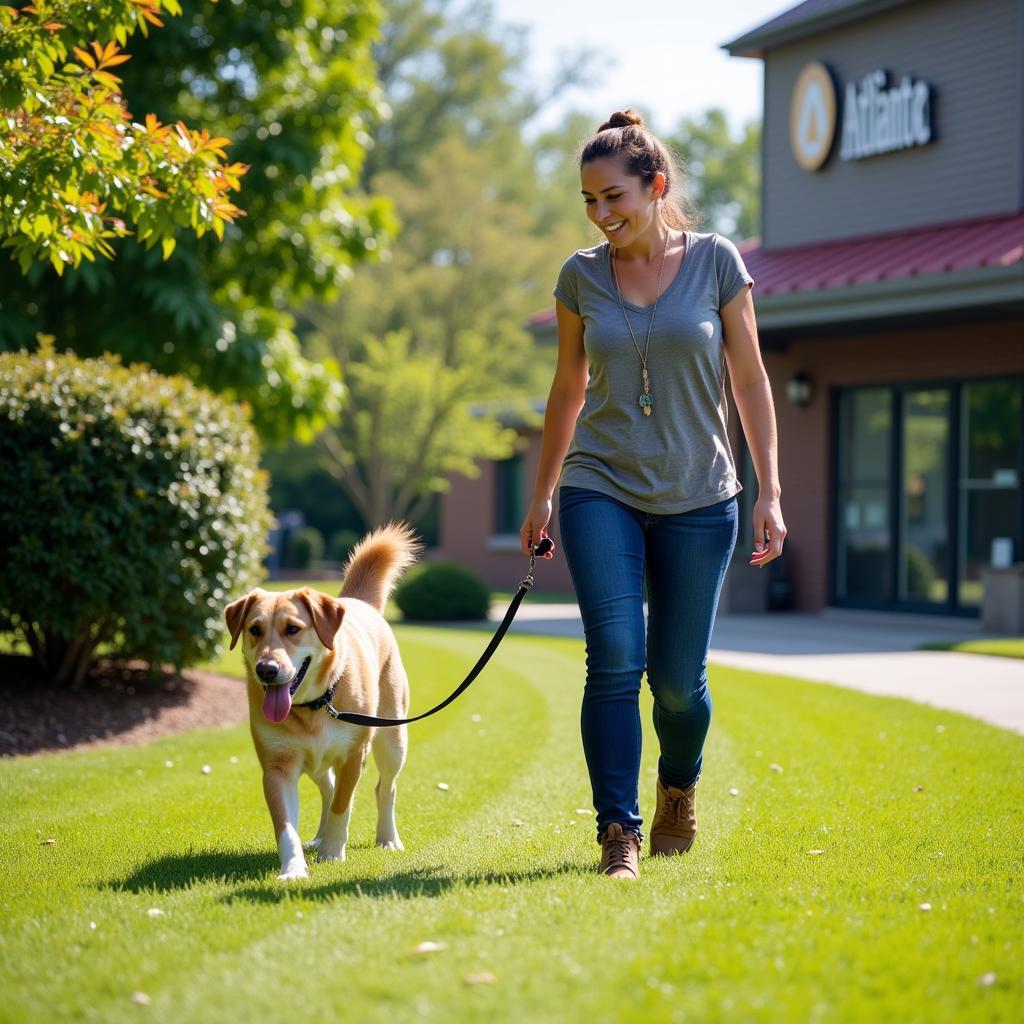 Atlanta Humane Society volunteer walking a dog