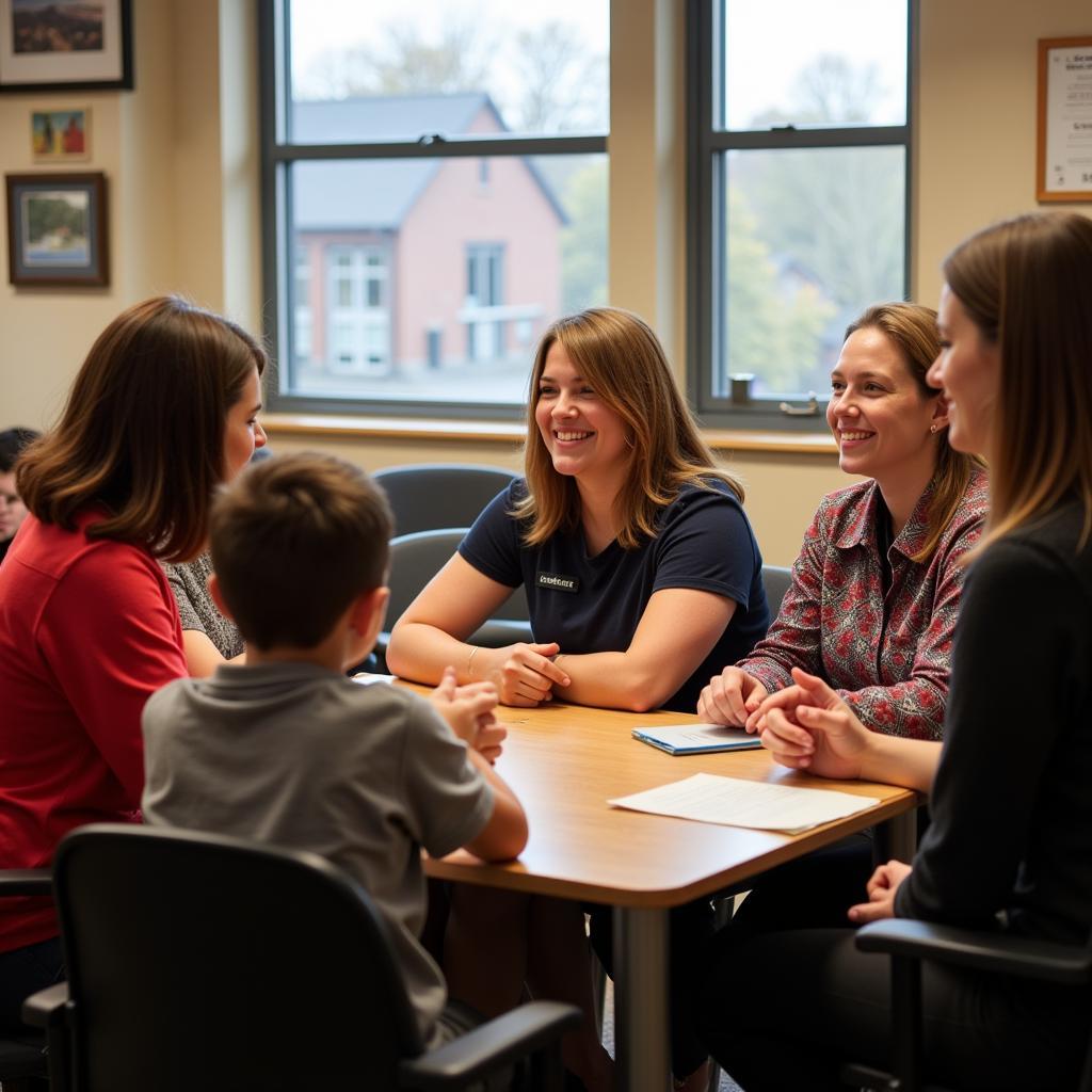 A support group meeting at the Autism Society of Pittsburgh with individuals with autism and their families engaging in discussion.