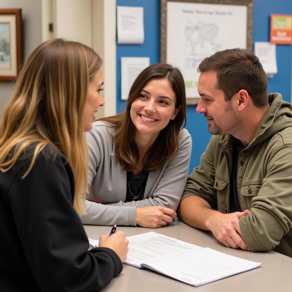 Smiling couple reviews adoption paperwork