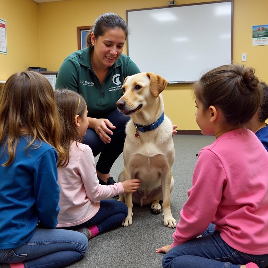 A Central Arizona Humane Society volunteer educates children about responsible pet ownership during a community outreach program.