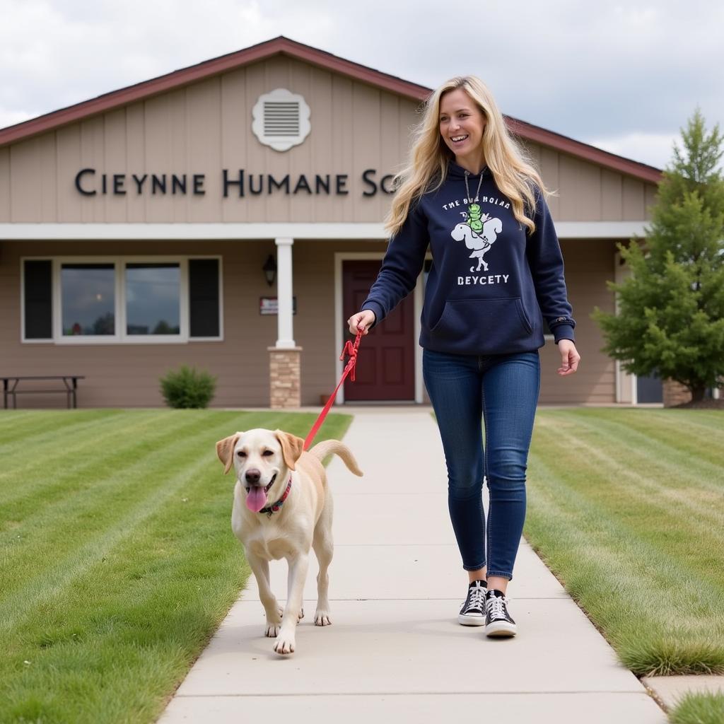 Volunteer walking a dog at the Cheyenne Humane Society