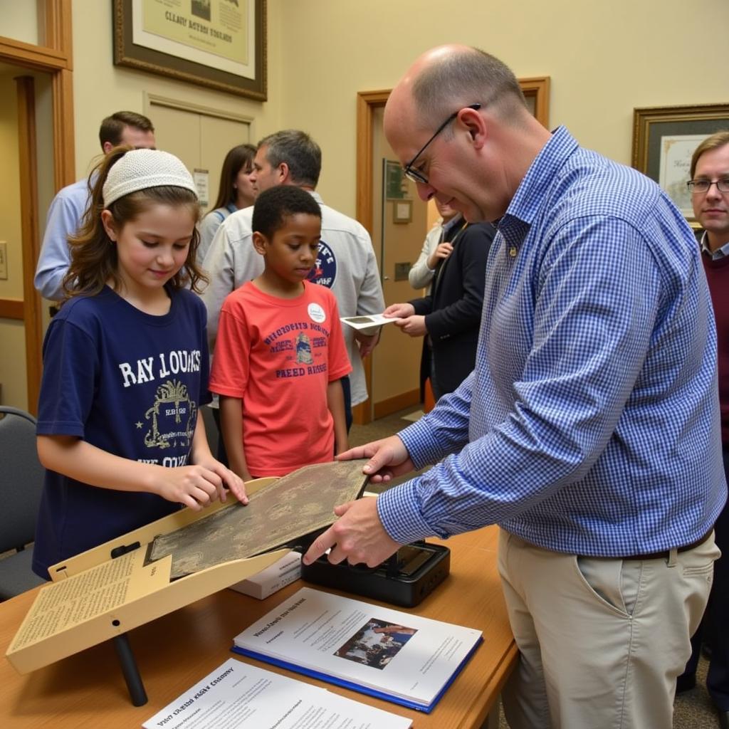 A group of people, including children and adults, looking at historical artifacts in a display case