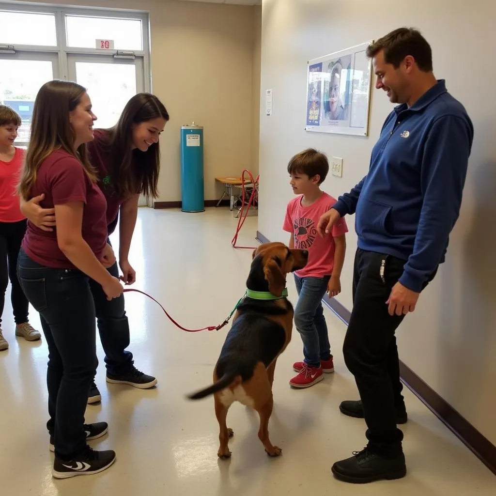 A family joyfully interacting with a dog at the Humane Society of Santa Monica