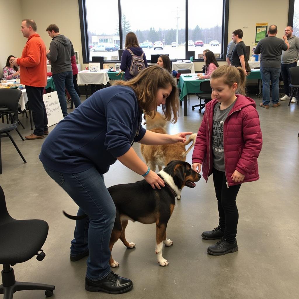 A heartwarming scene of families interacting with dogs at a Fond du Lac Humane Society adoption event.