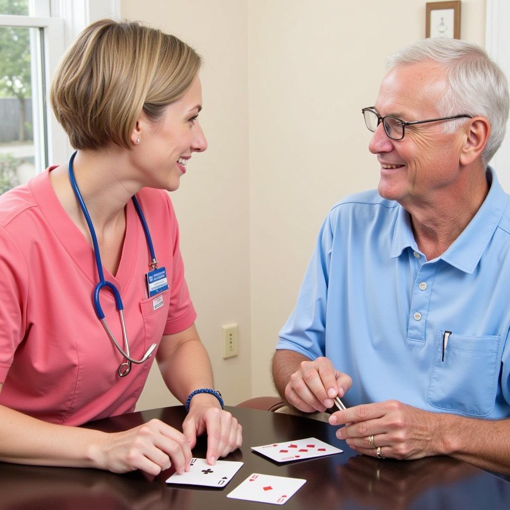 A Good Samaritan Society Home Care caregiver engages in a lively game of cards with a smiling senior man in his living room.