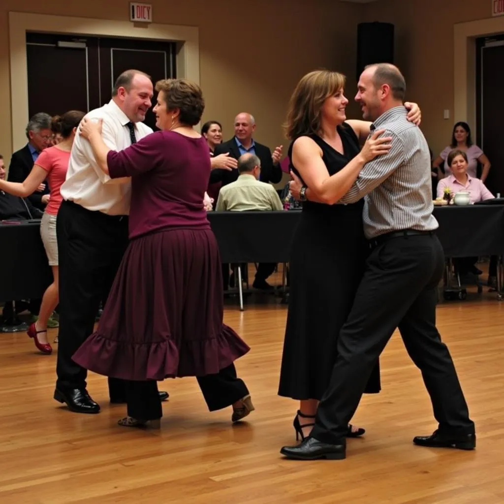 Couples swing dancing at a Grand Rapids Original Swing Society event