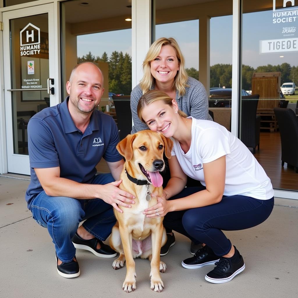 A happy family smiles with their newly adopted dog from the Humane Society Myerstown