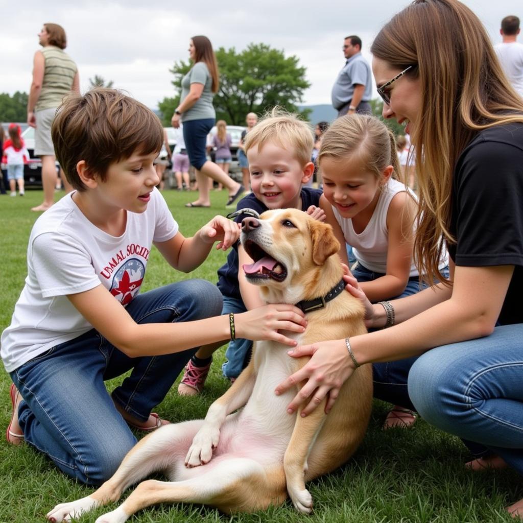 Family meeting a dog at an adoption event