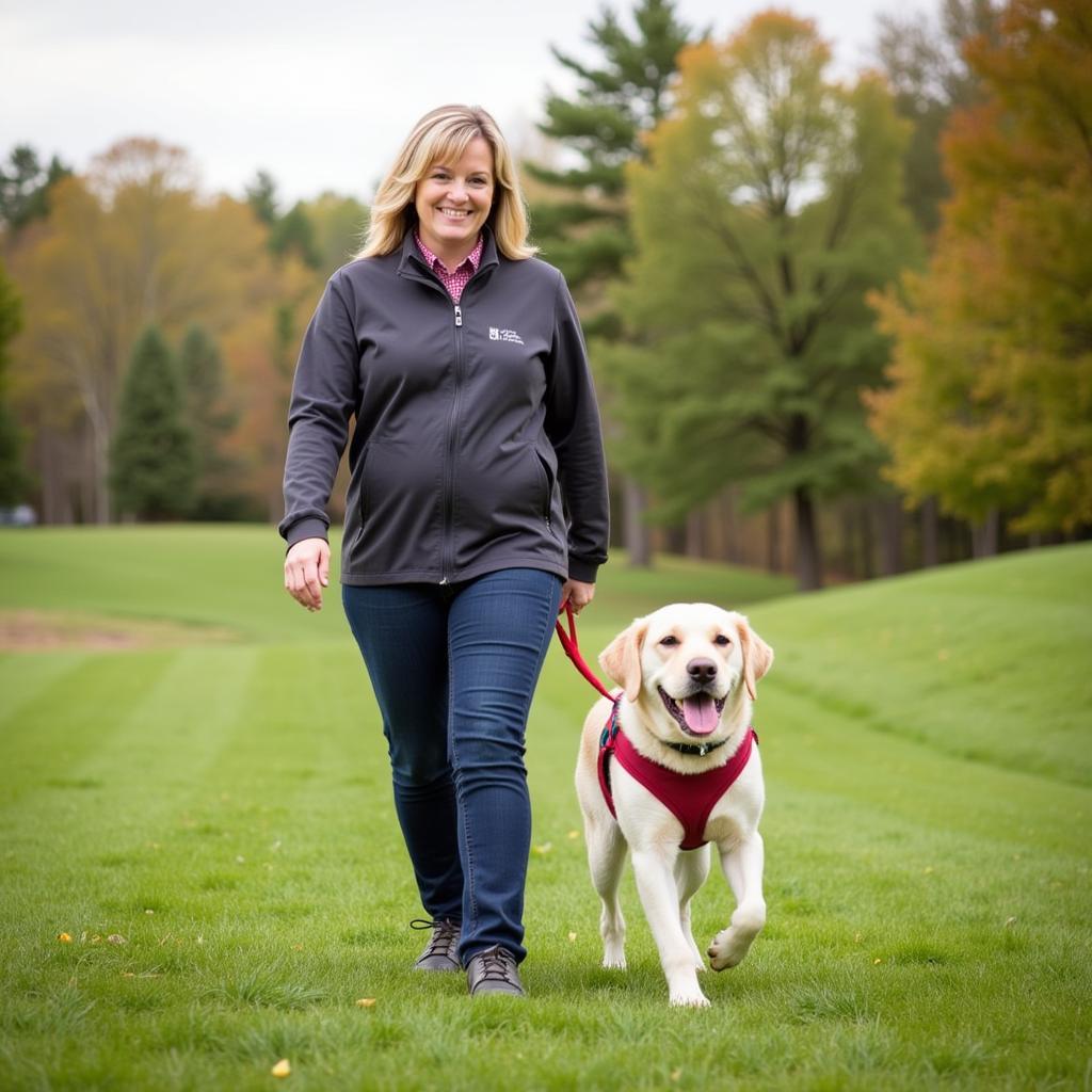 A volunteer walking a happy dog in a park, both enjoying the sunshine and fresh air