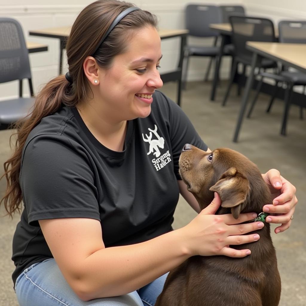 A volunteer spends quality time with a dog at the Lea County Humane Society