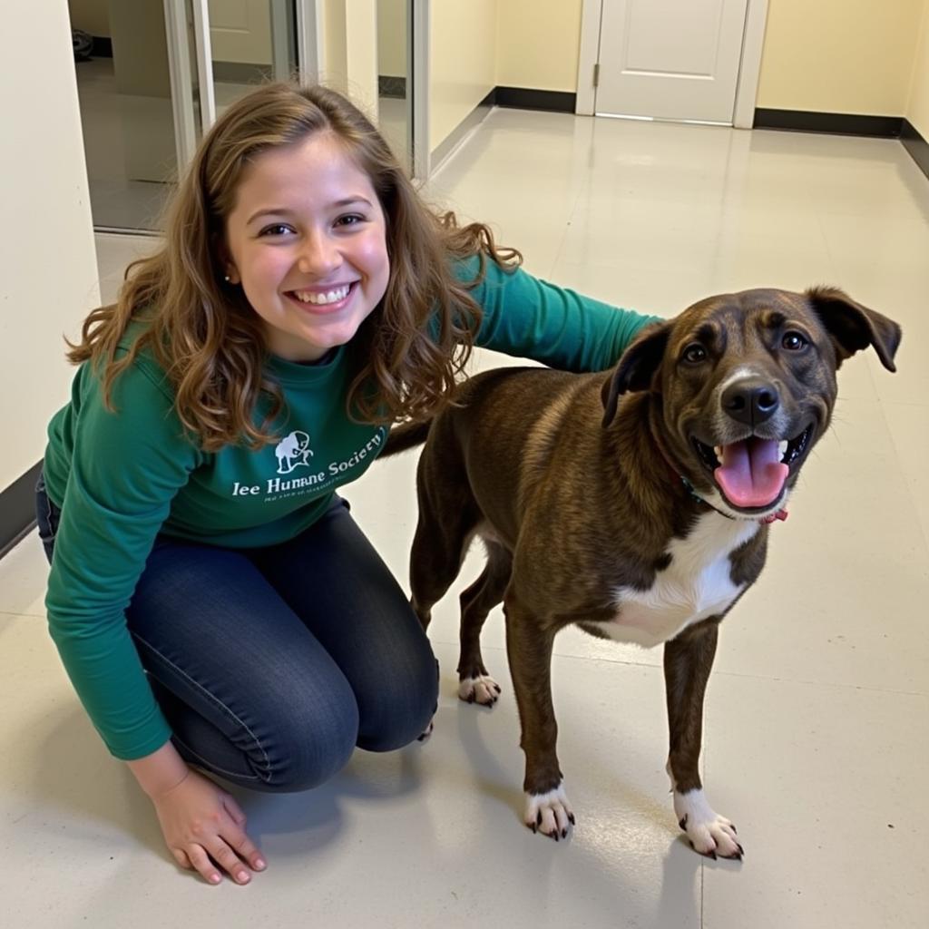 A volunteer shares a heartwarming moment with a shelter dog.