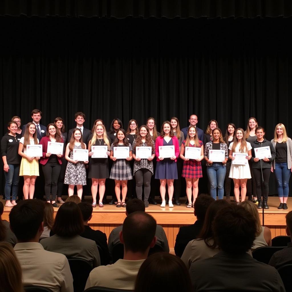 Students receiving National Honor Society certificates during an induction ceremony