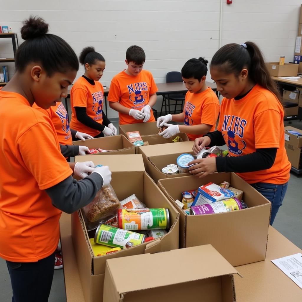 NJHS students wearing their shirts while volunteering at a local food bank