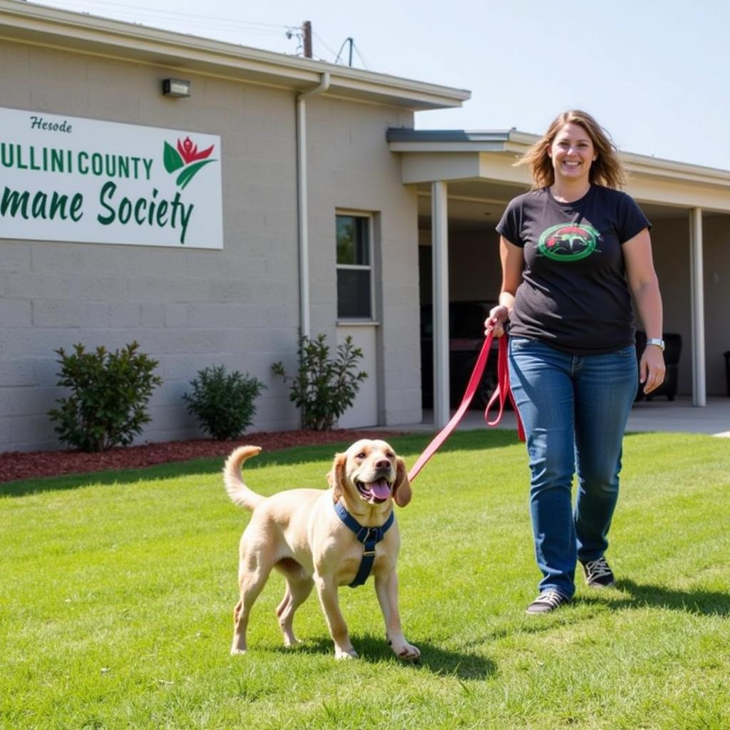 Volunteer walking a dog at the Paulding County Humane Society