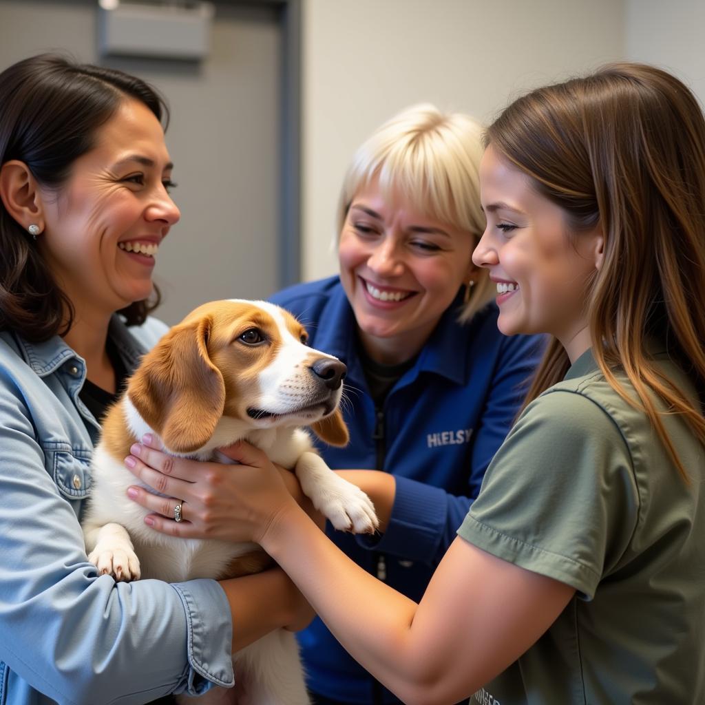  A friendly staff member at the Scott County Humane Society helping a family choose the right pet.