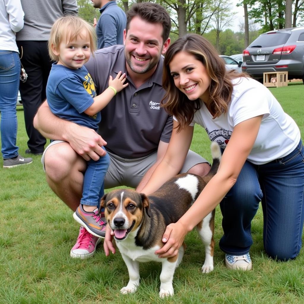 A family meeting a dog at a Shawano County Humane Society adoption event