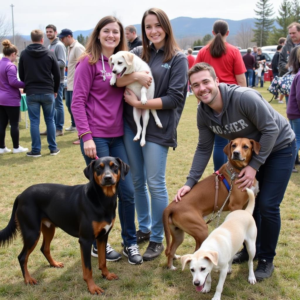 Families interact with adoptable dogs at a Sisters Humane Society adoption event