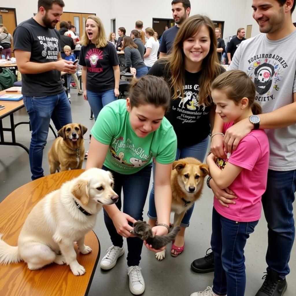 Families interacting with animals at a Tuscarawas County Humane Society adoption event