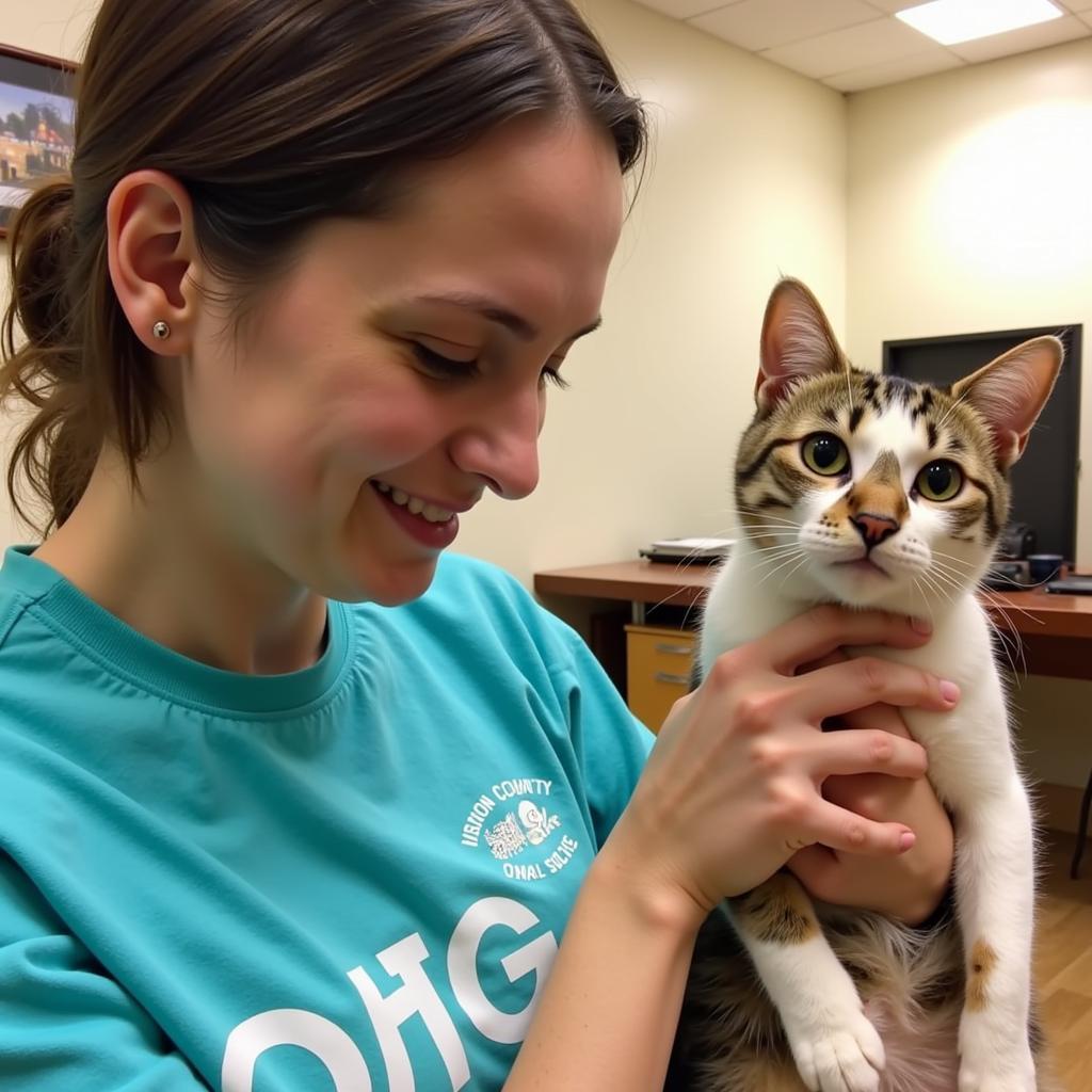 Cat cuddles with a potential adopter at Vernon County Humane Society