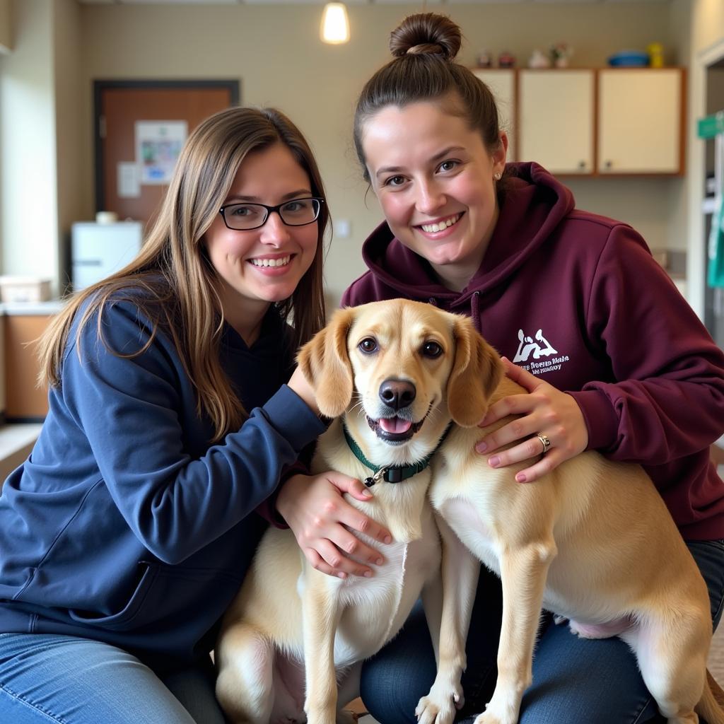 A volunteer smiles while walking a happy dog on a leash outside the Jamestown ND Humane Society.