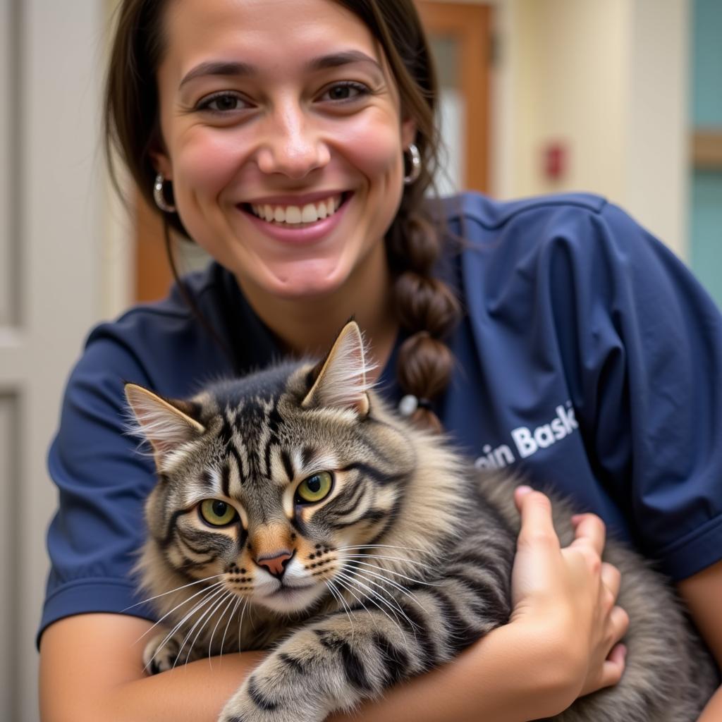 A volunteer cuddles a content cat inside the Humane Society of Wisconsin Rapids.