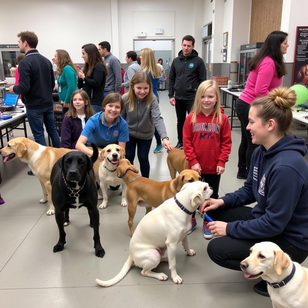 Erie Humane Society Adoption Event: Families interact with adoptable pets at a community adoption event hosted by the Erie Humane Society.