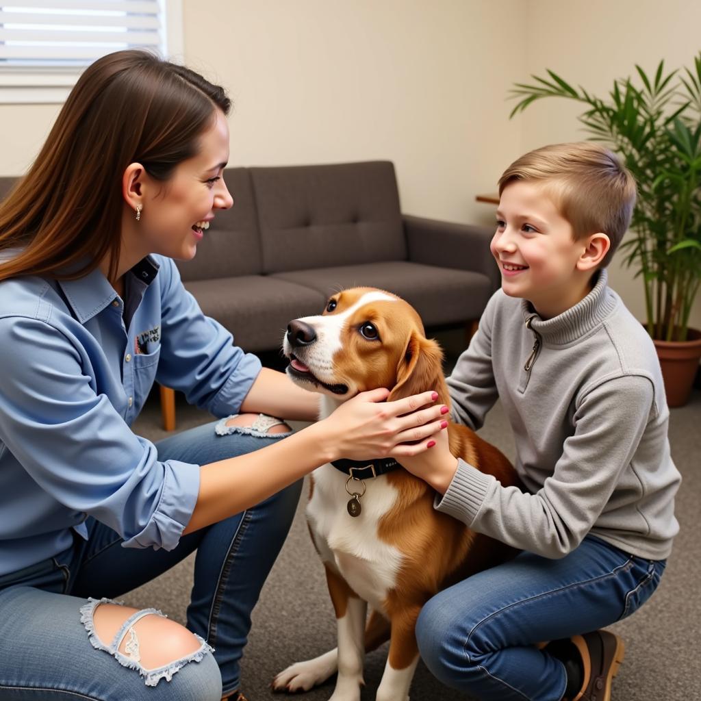 A family meeting an adoptable dog at the Grafton Humane Society, demonstrating a step in the adoption process.