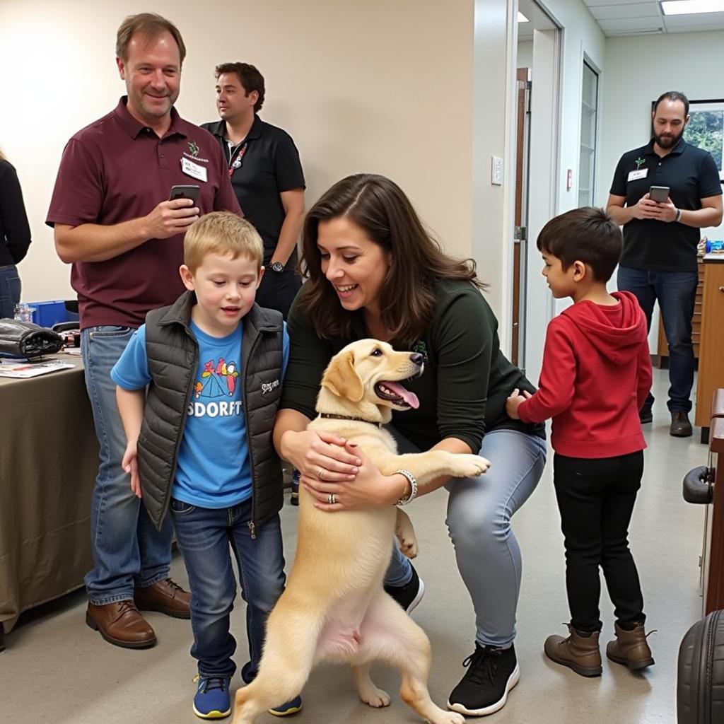 LTBHS Humane Society Adoption Event: A family meets a potential new pet at an adoption event.