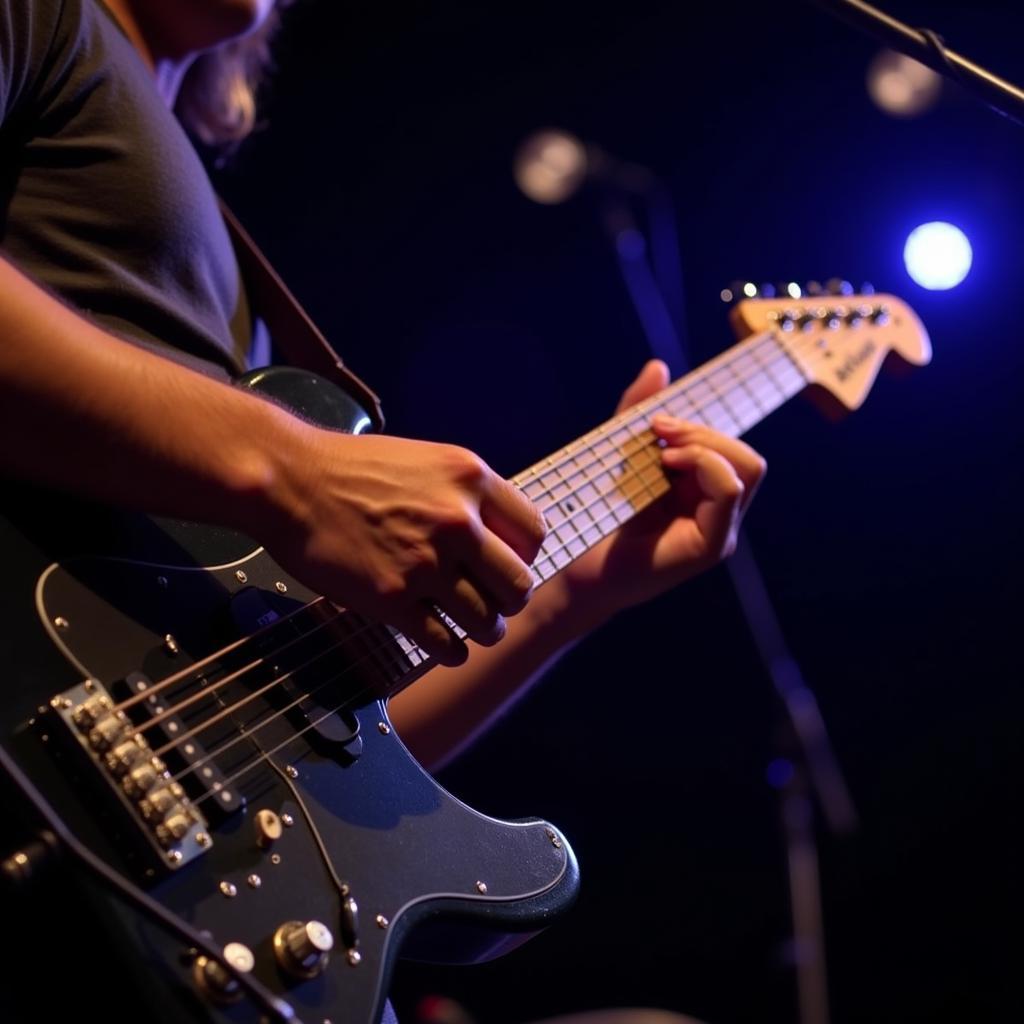 A musician passionately playing guitar on stage