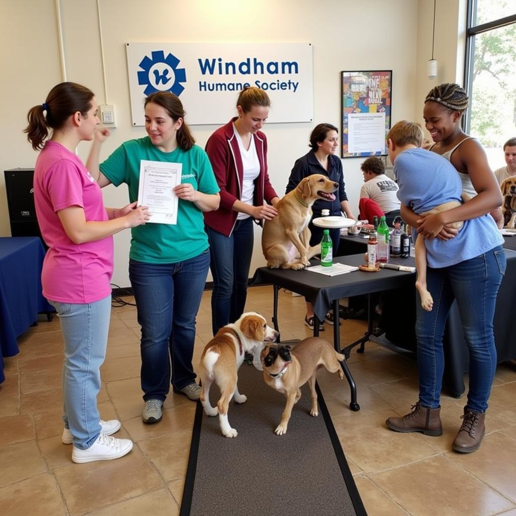 Volunteers and community members interacting with animals at a Windham Humane Society event.